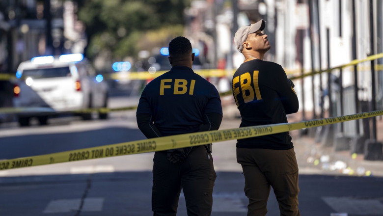 FBI agents survey the corners of Bourbon Street and Orleans Avenue, just a few blocks from where a man ramped a truck into a crowd at the edge of the French Quarter in the early morning hours of Wednesday, January 1, 2025, in New Orleans