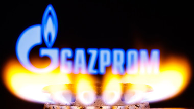 Gazprom is a Russian majority state-owned multinational energy corporation. Gas burner on the background of the Gazprom logo. Bright burning gas.