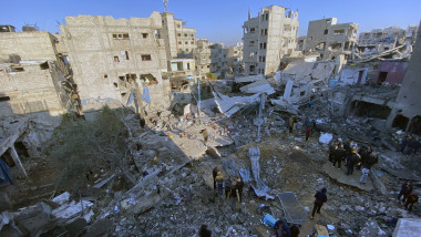 People search for their belongings amid the rubble of buildings destroyed in Israeli airstrikes in Gaza City