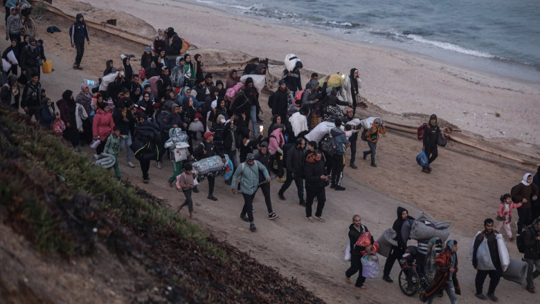 Palestinians, who were displaced to the south at Israel's order during the war, make their way back to their homes in northern Gaza, amid a ceasefire between Israel and Hamas, in the central Gaza Strip