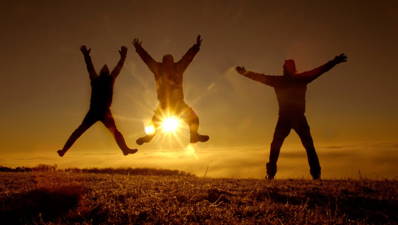 3 pagan revellers celebrate winter solstice as the sun rises in early morning