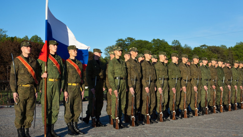 Military parade and soldiers with Russian flag and arms in line. Saint-Petersburg, Russia