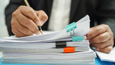 Businessman working and prepare paperwork report data to analysis information in file binder at office.