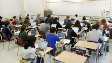 Students taking a test on laptops in a high school classroom. The test is the national PARCC test