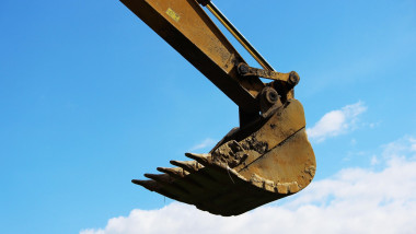 Bucket excavator against a background of the blue sky.