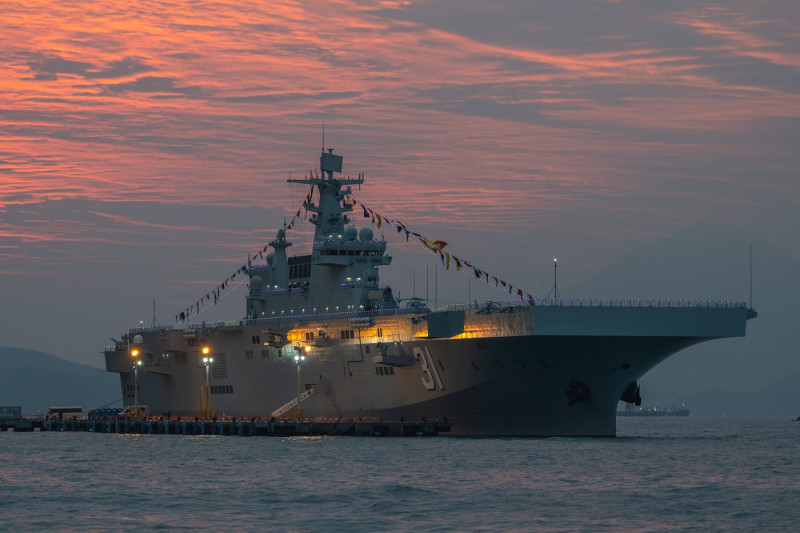 HONG KONG, CHINA - NOVEMBER 23: The Hainan amphibious assault ship berths at the China Merchants Wharf at sunset on Nove
