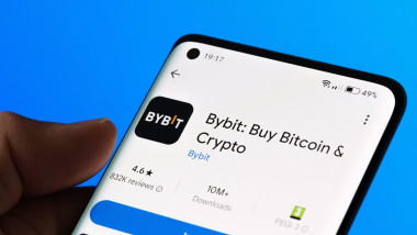 Bybit app installation page on a smartphone, showcasing features for buying Bitcoin and other cryptocurrencies. Bright blue background. Stafford, Unit