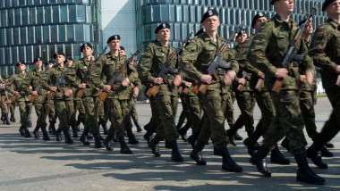 A marching group of Polish tank soldiers black hats Warsaw Poland