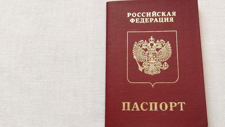 Passport of a citizen of the Russian Federation. International passport for travel and border crossing. Burgundy document cover with embossed gold letters. White background from textile