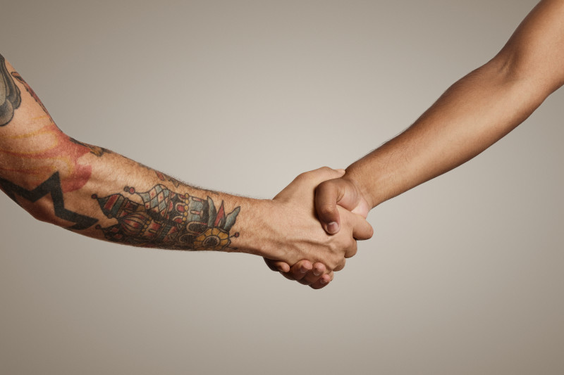 Firm,Handshake,Of,Two,Muscular,Men's,Hands,,One,With,Tattoos
