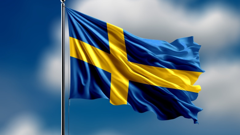 Sweden,Flag,Flying,On,Blur,Blue,Clouds,Background.