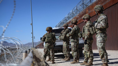 U.S. soldiers inspect a section of the border wall between US and mexico