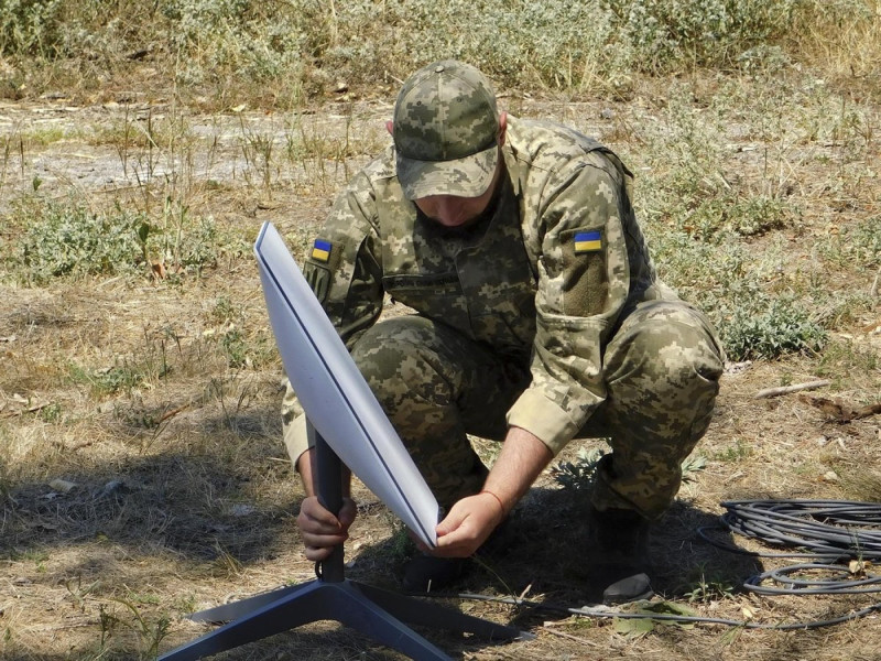Russian pro-war fanatics praise 'Colonel Elon Muskov' amid admissions Elon Musk's Starlink satellite equipment is in use by the Russian armed forces in occupied Ukraine. Pictured: Ukrainian soldier setting up Starlink satellite equipment