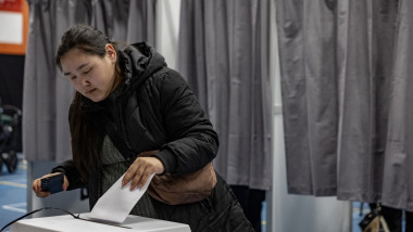 A woman casts her ballot at the polling station in Nuuk, Greenland, on March 11, 2025