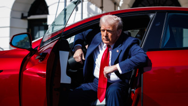 President Donald Trump views Tesla vehicles on the South Lawn driveway of the White House