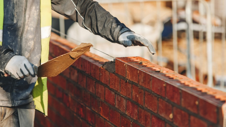 Worker,Laying,Bricks,At,A,Construction,Site