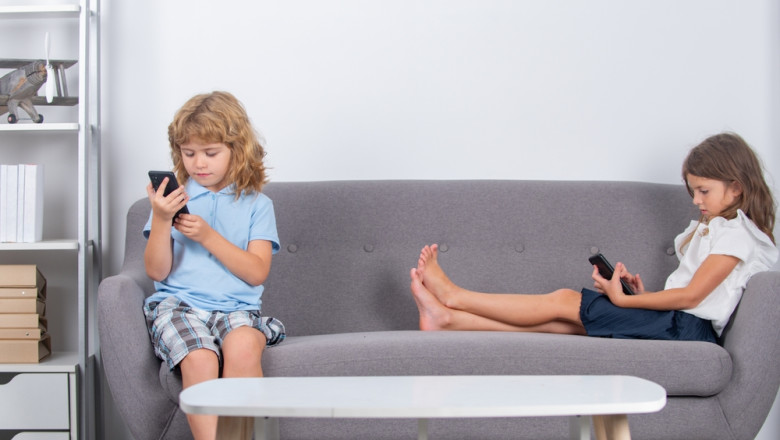Two,Children,Alone,With,Phone,At,Home.,Gadget,Addiction.,Mobile