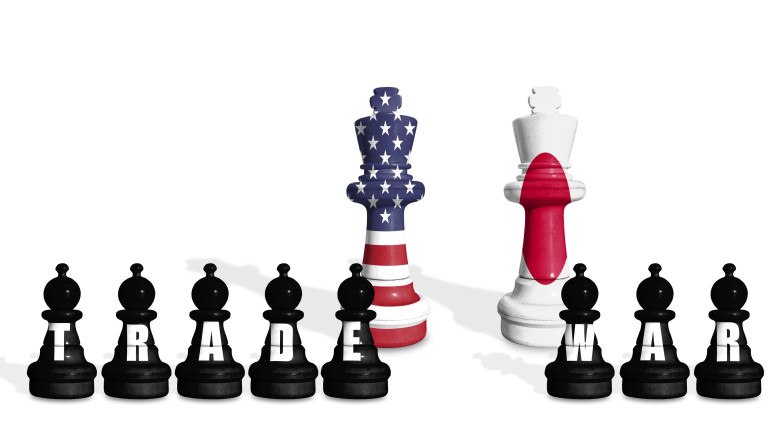 Chess made from US and Japan flags on a white background with word TRADE WAR