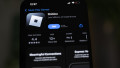 Company logos displayed on smartphone, Poland - 03 Mar 2025