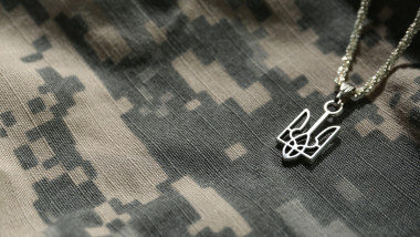 Chain with Ukrainian coat of arms on military uniform, closeup
