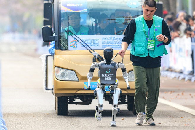 BEIJING, CHINA - APRIL 19: A N2 humanoid robot developed by Noetix Robotics competes in the Beijing E-town Half-Marathon
