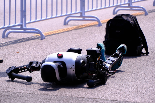 BEIJING, CHINA - APRIL 19: A humanoid robot runner falls in the Beijing E-town Half-Marathon and Humanoid Robot Half-Mar