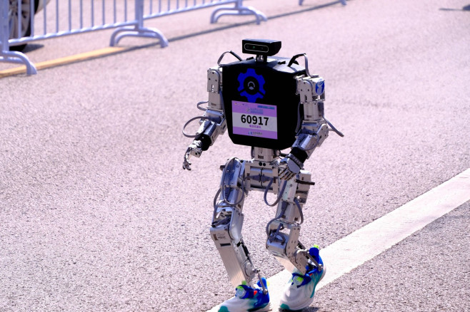 BEIJING, CHINA - APRIL 19: A humanoid robot runner competes in the Beijing E-town Half-Marathon and Humanoid Robot Half-