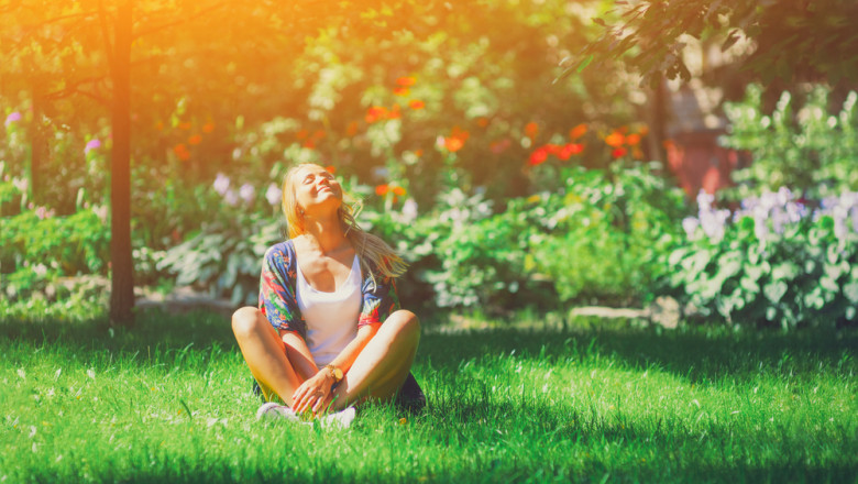 Happy,Free,Young,Woman,Sitting,Outdoors,In,Yoga,Position,With
