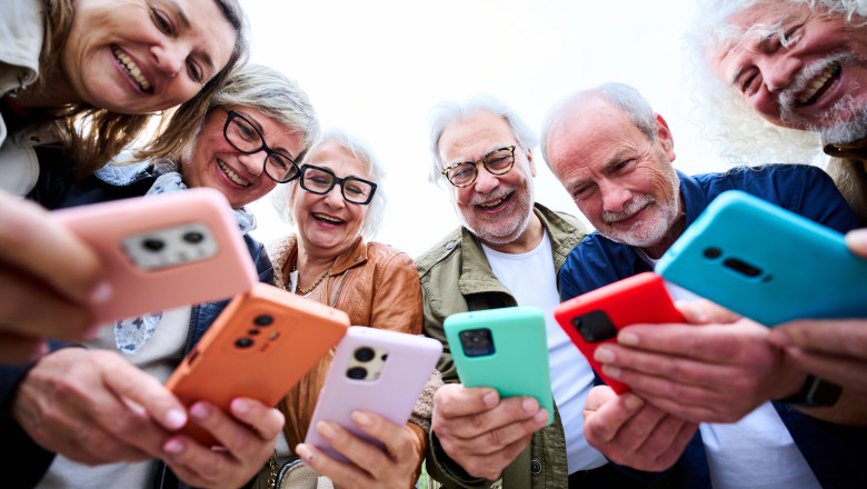 Group,Of,Seniors,Caucasian,Smiling,People,Together,Using,Colourful,Smart