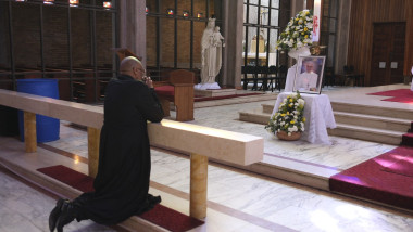 Father Lawrence Mduduzi Ndlovu prays in front of a shrine dedicated to the late Pope Francis at the Cathedral of Christ the King Catholic Church in Johannesburg on April 21, 2025.