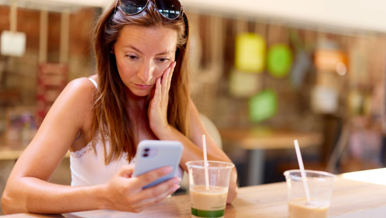 Woman looking shocked looking at TikTok