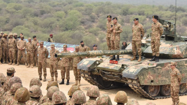 Pakistan's Army Chief General Syed Asim Munir (Top 3R) standS on military tank speaks with army troops to witness exercise 'Hammer Strike'