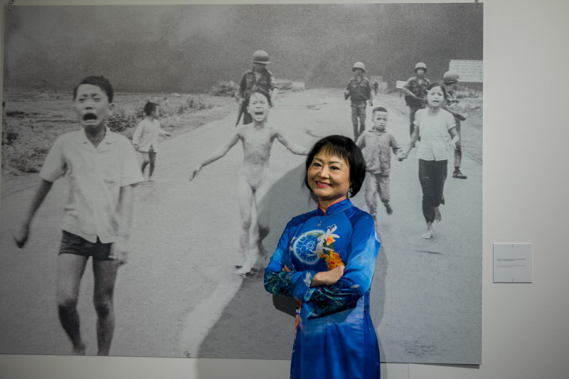 Italy, Milan: From Hell to Hollywood, photo exhibition by Nick Ut at Palazzo Lombardia. Vietnamese woman Kim Phuc poses in front of the famous photo 1973 Pulitzer Prize winning photo 'Napalm girl' by Nick Ut
