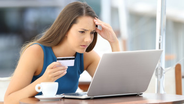 Worried shopper paying with credit card