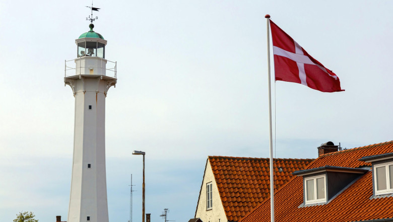 Lighthouse with the Danish flag in a small town Ronne, Bornholm, Denmark . High quality photo