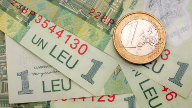Romanian one leu banknotes and a one euro coin