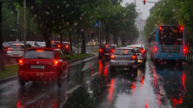 Bucharest, Romania - June 17, 2020: The cars are waiting at the red traffic light during the rain on Kiseleff Boulevard in Bucharest.