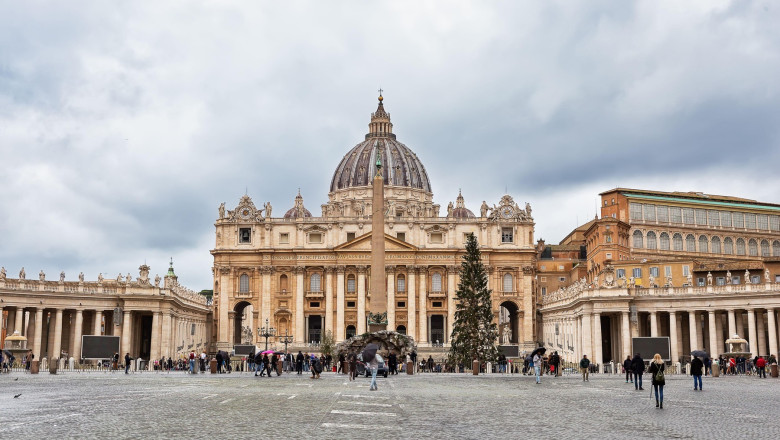 View of St. Peter's Basilica and and Saint Peter's Square in the Vatican city against cloudy dramayic sky, Rome, Italy.