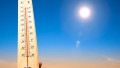 hand holding thermometer and heat weather