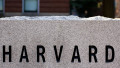 etail of a granite marker in a driveway at Harvard University campus in Cambridge, MA, showing the letters HARVARD