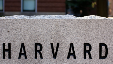 etail of a granite marker in a driveway at Harvard University campus in Cambridge, MA, showing the letters HARVARD