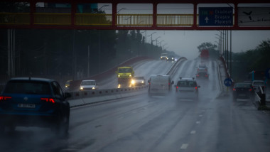 Otopeni, Romania - June 17, 2020: Cars run in the rain on a low visibility segment of the European route E60 on a bridge near Bucharest Henri Coanda I