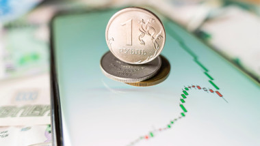 money. russian ruble. smartphone with exchange rates screen is on the notebook. The rise of the exchange rate on the stock exchange. revaluation conce