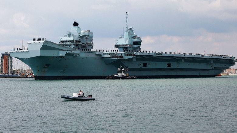 Portsmouth, UK. August 27th 2022. Aircraft Carrier HMS Prince of Wales seen leaving the harbour of Portsmouth. Credit: Joe Kuis / Alamy Reportage