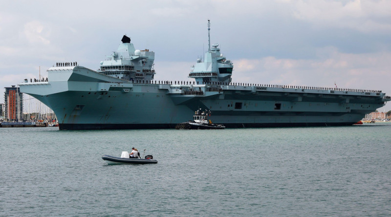 Portsmouth, UK. August 27th 2022. Aircraft Carrier HMS Prince of Wales seen leaving the harbour of Portsmouth. Credit: Joe Kuis / Alamy Reportage