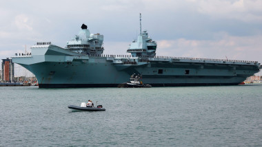 Portsmouth, UK. August 27th 2022. Aircraft Carrier HMS Prince of Wales seen leaving the harbour of Portsmouth. Credit: Joe Kuis / Alamy Reportage