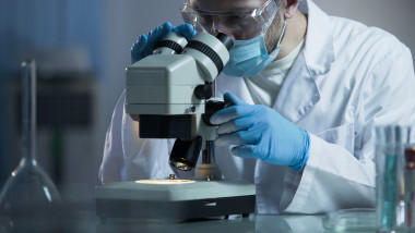 Male,Scientist,Looking,Into,Microscope,,Working,On,Aids,Treatment,Vaccine