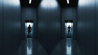A dark corridor intersection with open elevators—one with a human silhouette entering, the other with a humanoid robot stepping out