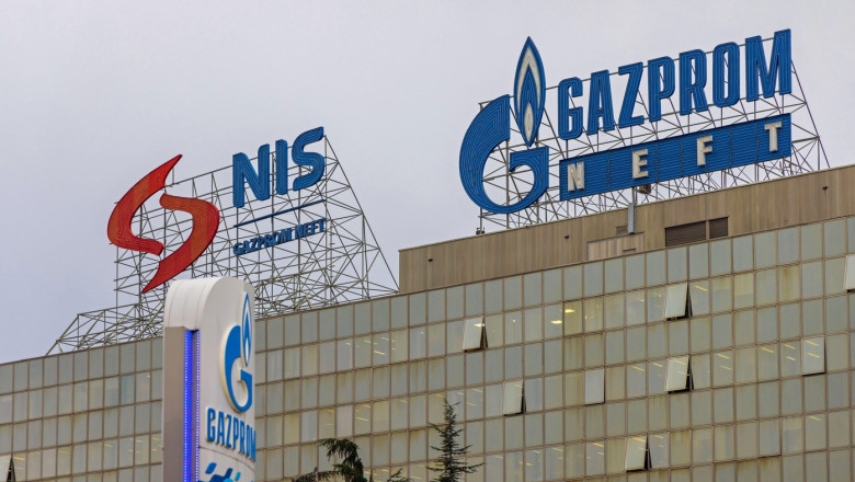 Belgrade, Serbia - December 27, 2021: Russian Oil Company Gazprom Neft and Nis Signs at Top of Office Building.
