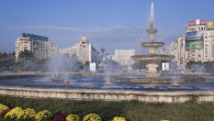 Piata Unirii fountain with the Palace of Parliament building behind, Piata Unirii, Bucharest, Romania, Europe